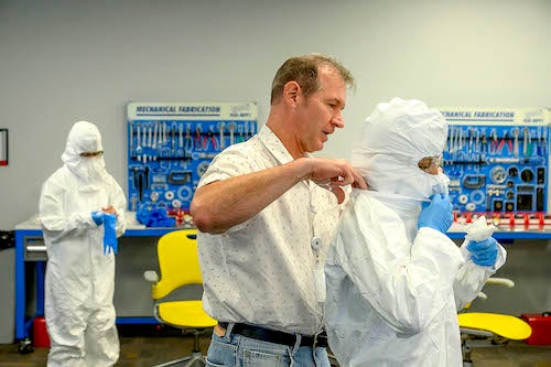 Technicians suit up in class