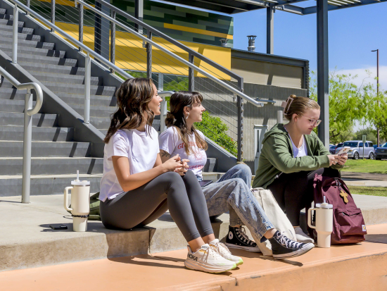 Students sitting on stairs in Ironwood Building"