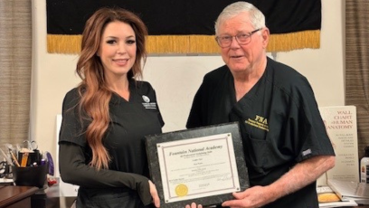 Jamie Thompson and Vernie R. Fountain pose with Jamie's Fountain National Academy certificate of completion