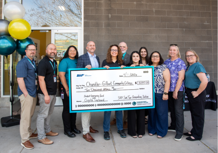 CGCC and SRP leadership pose with $10,000 check outside the Coyote Cupboard at CGCC's Pecos campus