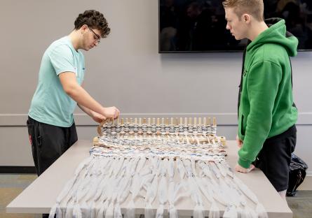 Students weave plastic grocery bags into mats for the homeless during the Plarn Service-Learning project.