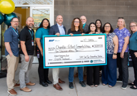 CGCC and SRP leadership pose with $10,000 check outside the Coyote Cupboard at CGCC's Pecos campus