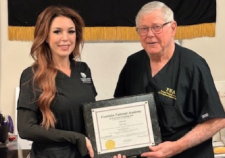 Jamie Thompson and Vernie R. Fountain pose with Jamie's Fountain National Academy certificate of completion
