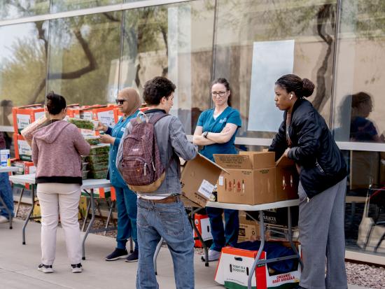 Students collecting fresh produce during a distribution event at CGCC to support student food assistance programs.