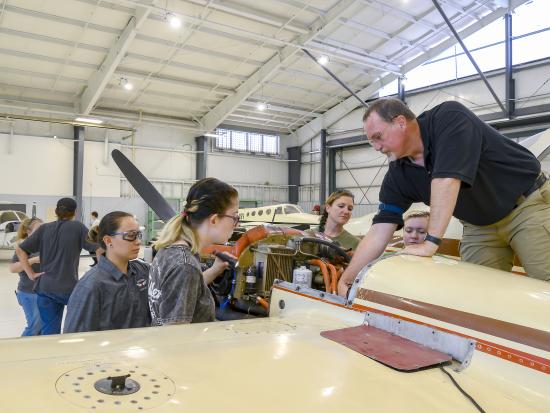 Teacher with students in an aircraft maintenance class