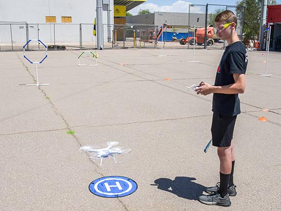 Student flying a drone.