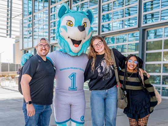 3 CGCC Students Posing With Cody the Coyote