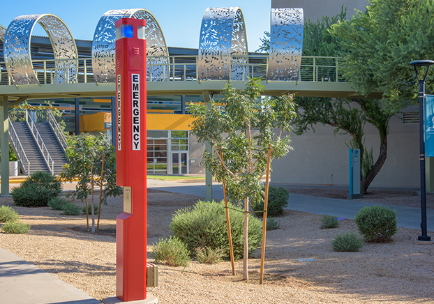 An emergency pole in red in front of the Pecos Campus 