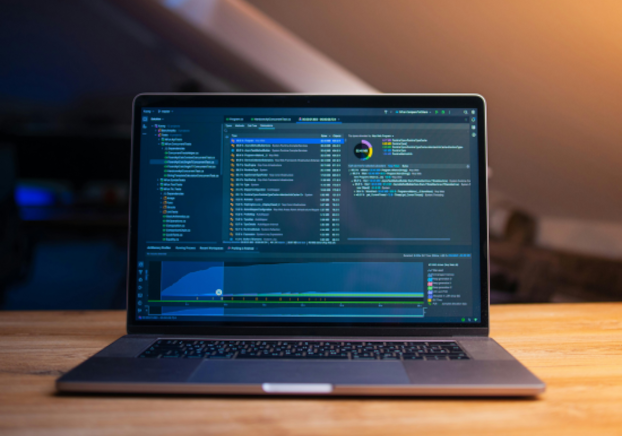 Laptop displaying Python code on the screen, used for programming and data analysis.